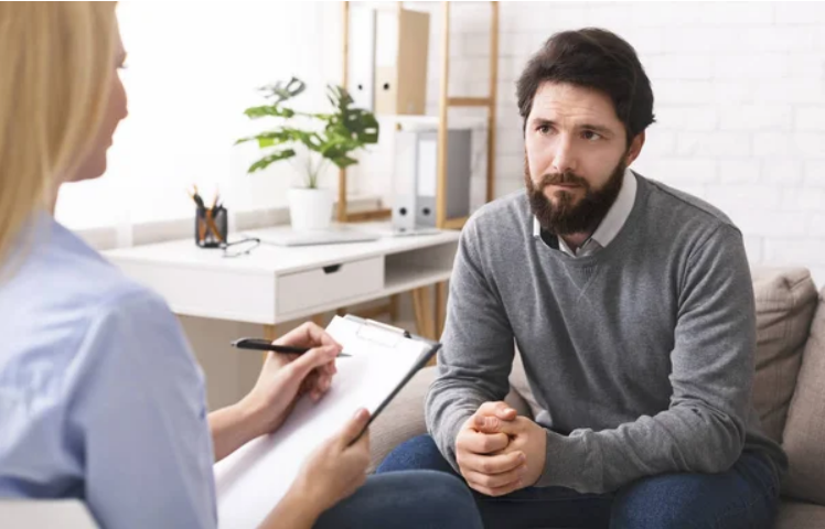 A man consulting doctor for ptsd treatment